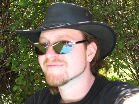 This is a picture of me at the Maryland Wine Festival a few weeks back.  Note the angle of the head, accentuating the jaw-line; the use of the &quot;line beard&quot;, a trick of fatties everywhere to shadow the jaw and make the face look thin; the jaunty Outback hat covering the balding pate; the cool as ice shades obscuring the lazy-eye.  Yeah, to look at this picture of me is to realize that I'm every bit the sexy beast half of you imagine me to be.  This is what photographers refer to as &quot;a Facebook photo&quot;.